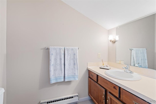 bathroom with toilet, a baseboard radiator, vaulted ceiling, and vanity