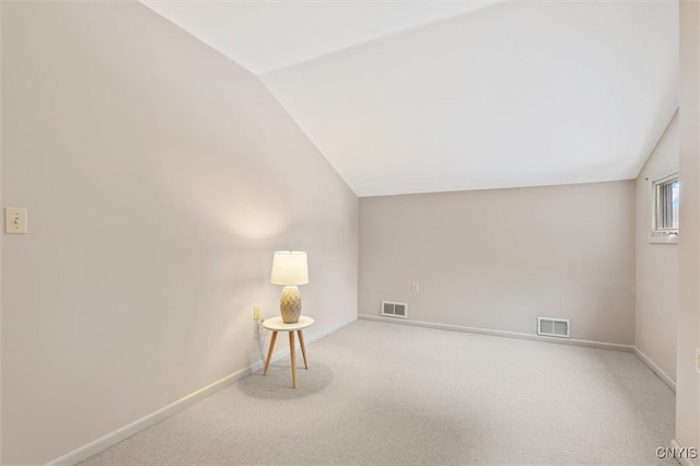 bonus room featuring lofted ceiling, carpet floors, visible vents, and baseboards