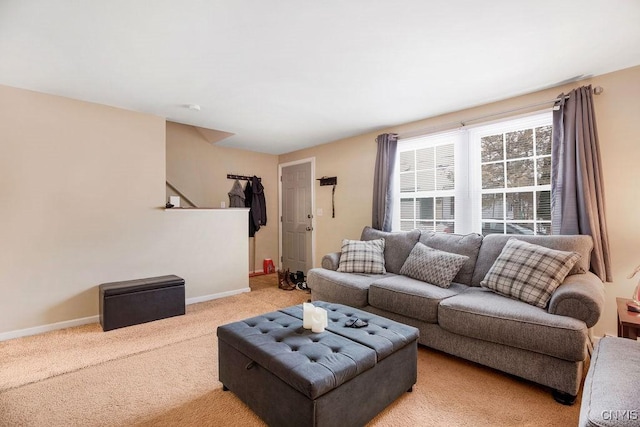 living room with light carpet and baseboards