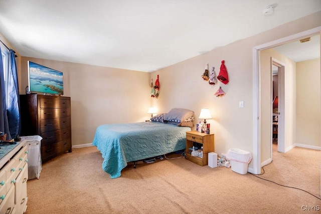 bedroom with baseboards and light colored carpet