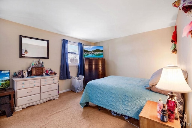 bedroom featuring carpet and baseboards