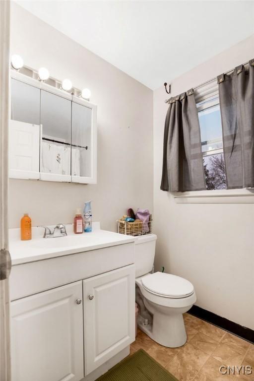 bathroom featuring toilet and vanity