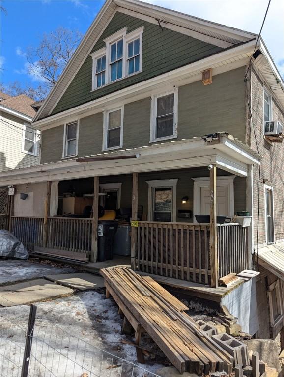 view of front facade with covered porch and cooling unit