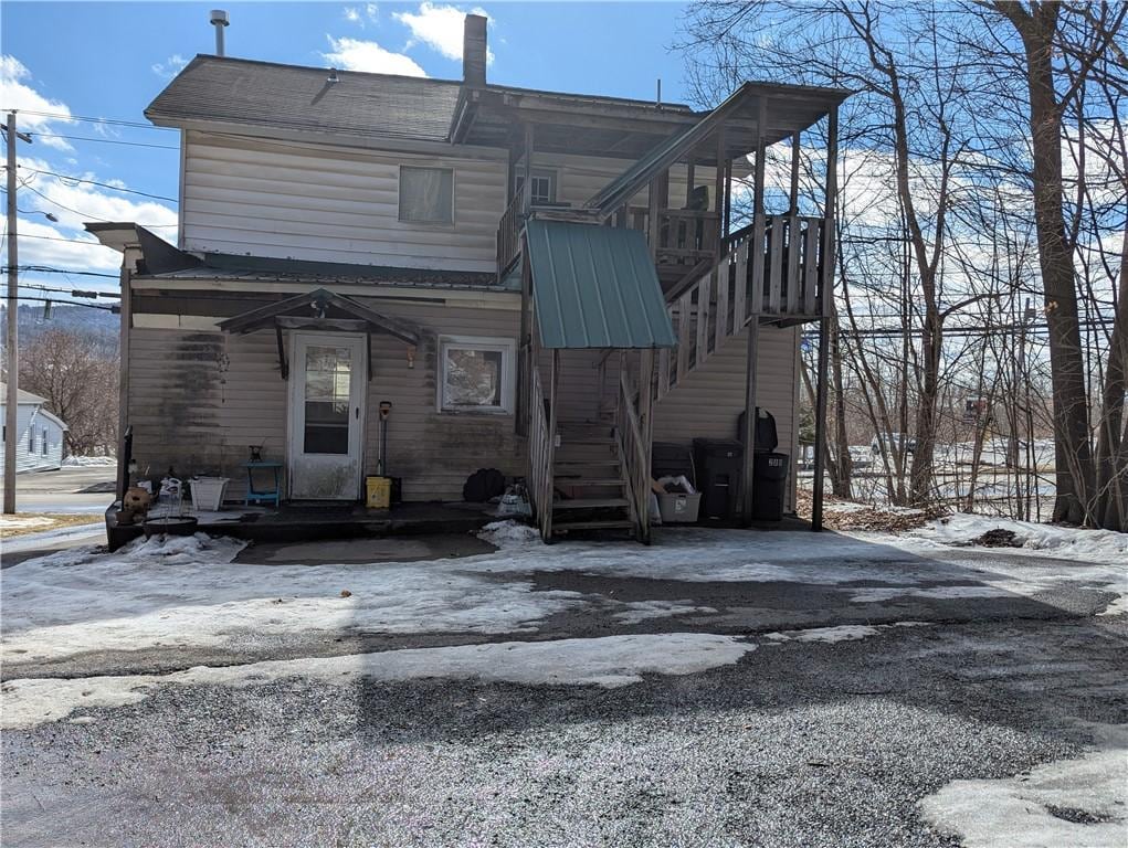 snow covered house with stairs