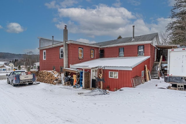 snow covered house with stairs