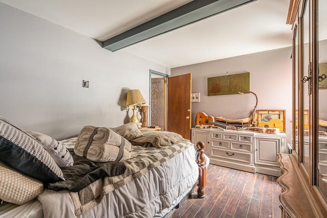 bedroom featuring dark wood-type flooring and beamed ceiling