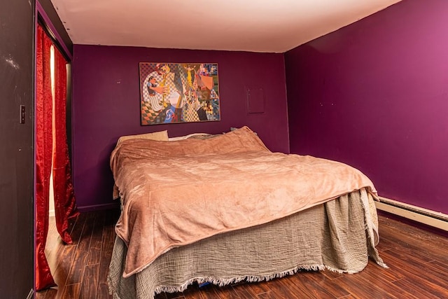 bedroom with wood finished floors and baseboards