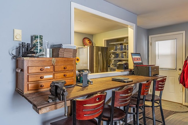 interior space with wood finished floors and freestanding refrigerator