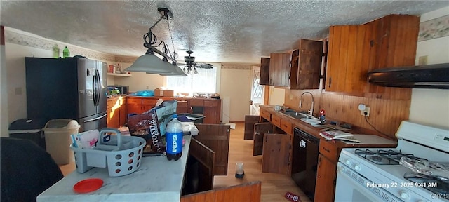 kitchen featuring black dishwasher, stainless steel refrigerator with ice dispenser, gas range gas stove, a textured ceiling, and extractor fan