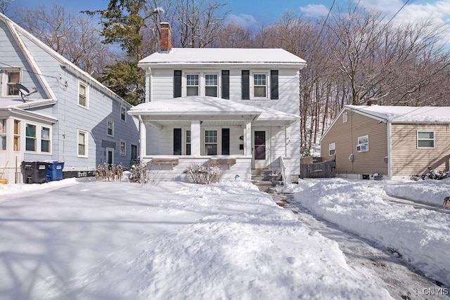 view of front of home with a porch and a chimney