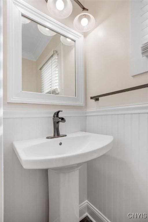 bathroom with a wainscoted wall