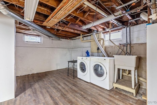 laundry area with laundry area, wood finished floors, and independent washer and dryer