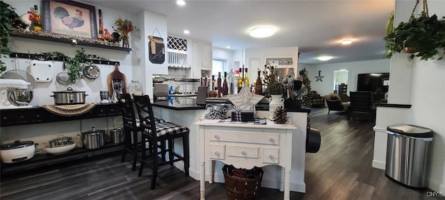 kitchen featuring a peninsula, dark wood-style floors, white cabinets, and recessed lighting