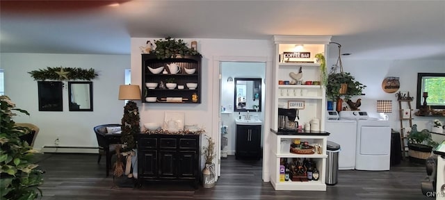 bar with a baseboard radiator, washer and clothes dryer, and wood finished floors