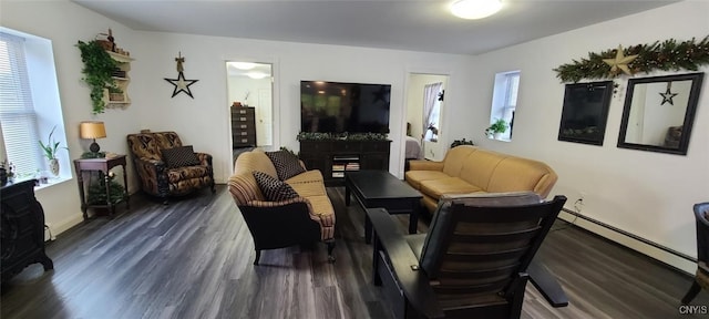 living area featuring a fireplace, baseboard heating, and dark wood-type flooring