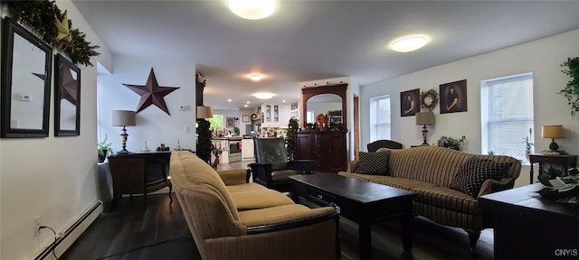 living area with a baseboard radiator and dark wood finished floors