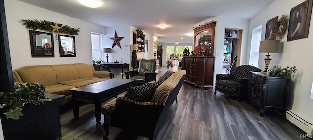 living room featuring dark wood-style flooring and a baseboard radiator