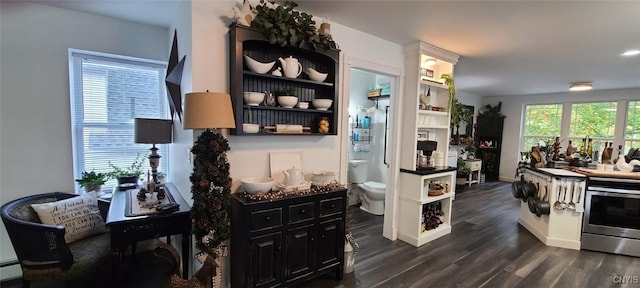 kitchen with dark countertops, dark wood-style floors, a baseboard radiator, stainless steel range with electric stovetop, and open shelves