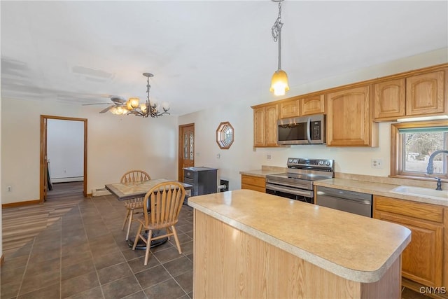 kitchen with a kitchen island, stainless steel appliances, a sink, and light countertops