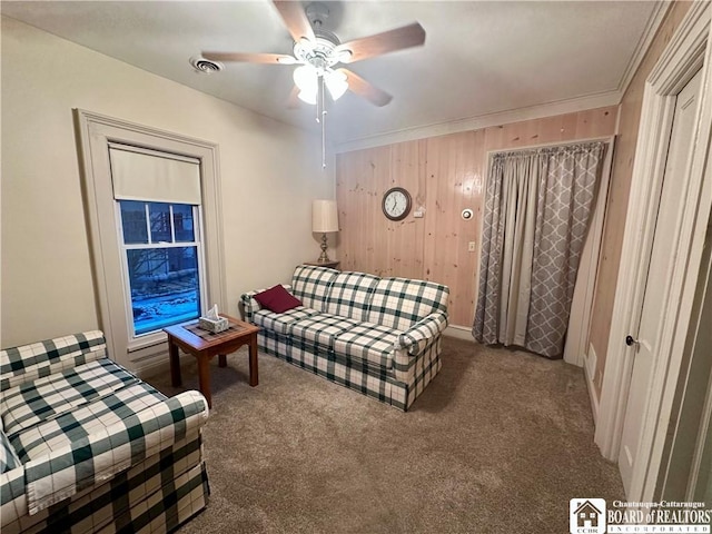 living room featuring carpet floors, ceiling fan, and visible vents