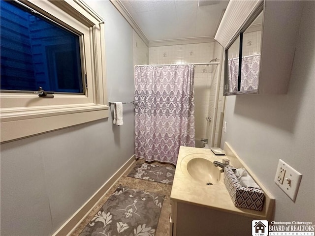 bathroom featuring crown molding, curtained shower, vanity, and baseboards