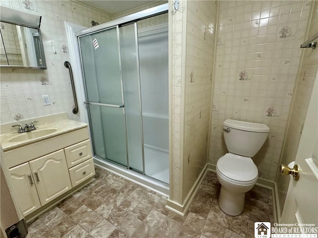 bathroom featuring toilet, a shower stall, tile walls, and vanity