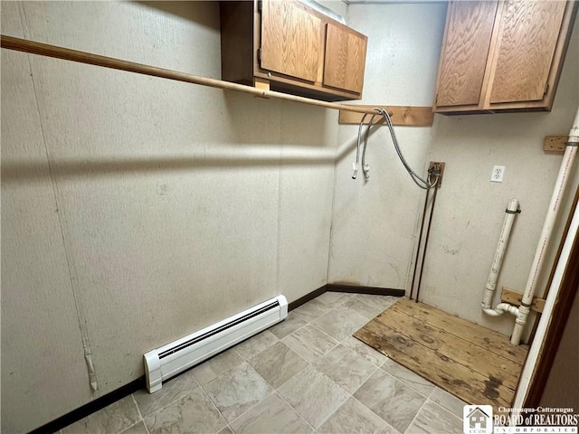 interior space with cabinet space and baseboard heating