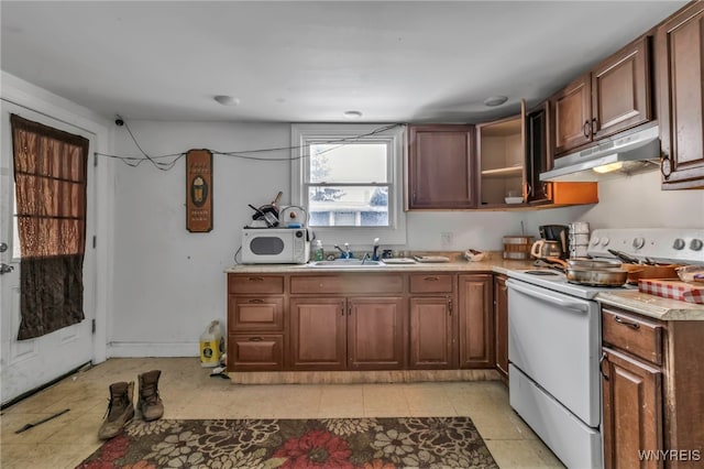 kitchen featuring under cabinet range hood, white appliances, a sink, light countertops, and open shelves