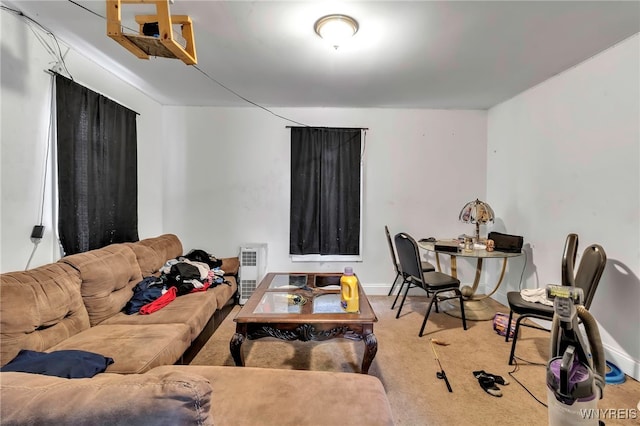 carpeted living area featuring baseboards