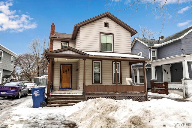 view of front of property featuring a porch and a chimney