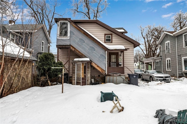 view of snow covered rear of property