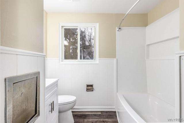 full bath with a wainscoted wall, vanity, toilet, and wood finished floors