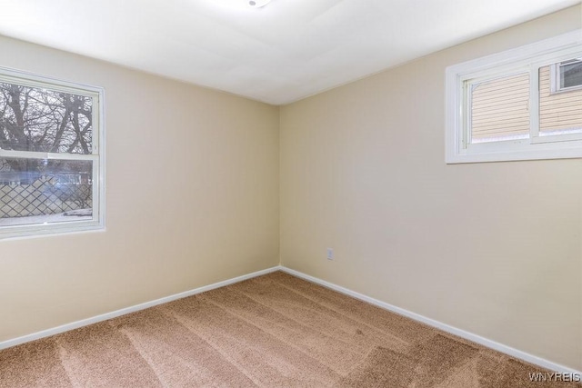 carpeted empty room with baseboards