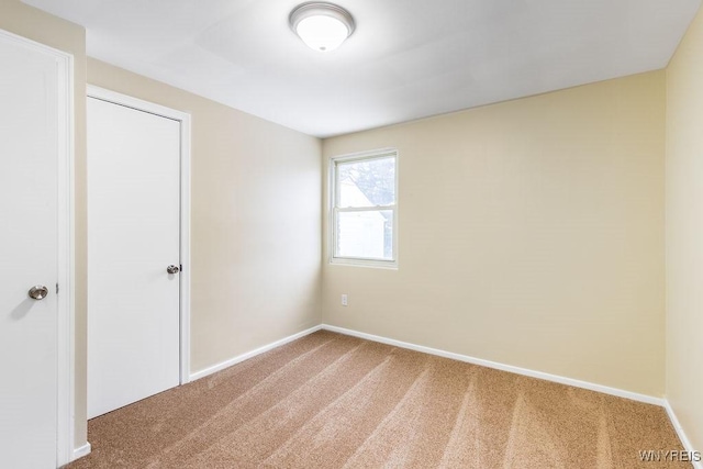 empty room with carpet floors and baseboards