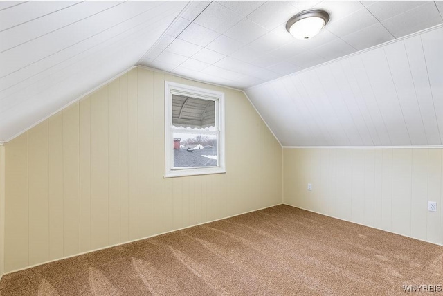 bonus room featuring vaulted ceiling and carpet flooring