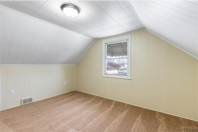 bonus room featuring lofted ceiling, visible vents, and carpet flooring