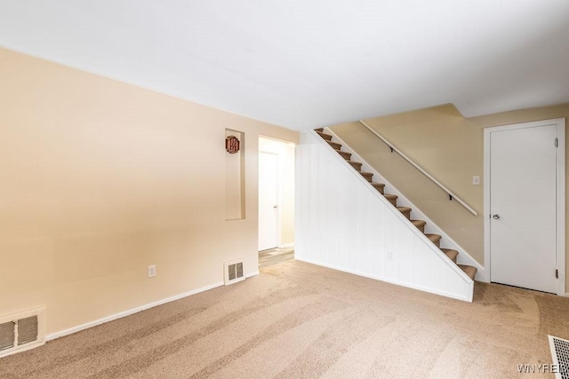 interior space featuring stairway, visible vents, and baseboards