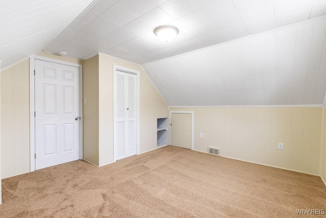 bonus room featuring carpet, visible vents, and lofted ceiling