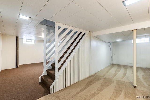 basement with carpet and stairs