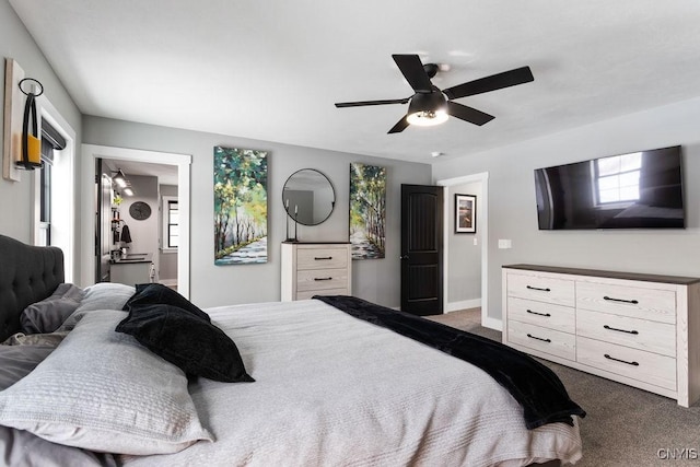 bedroom featuring baseboards, dark colored carpet, and a ceiling fan