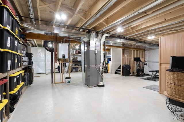 unfinished basement with stairway, tankless water heater, and heating unit