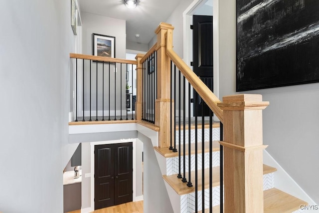 stairway with wood finished floors