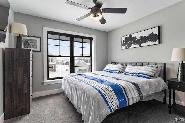 carpeted bedroom with ceiling fan and baseboards