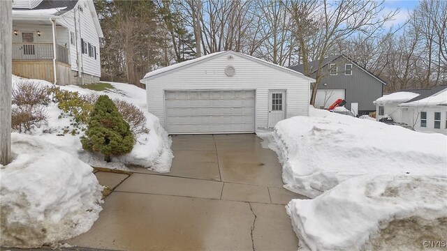 snow covered garage with a garage