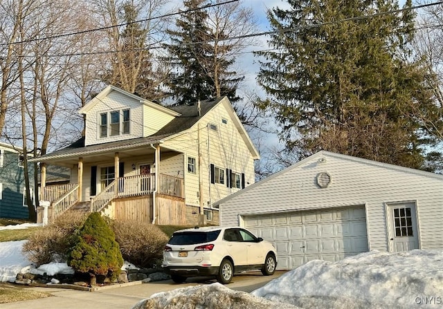 view of front facade with a porch, an attached garage, and driveway