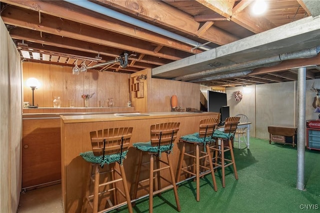 bar featuring a dry bar and wood walls