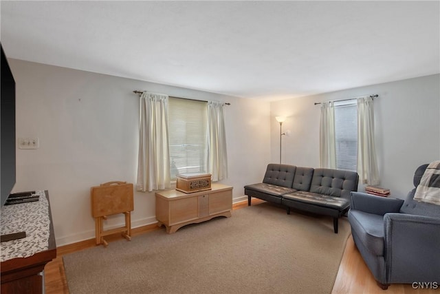 living room with light wood-type flooring and baseboards