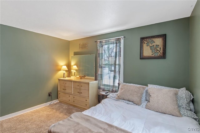 bedroom featuring light carpet and baseboards