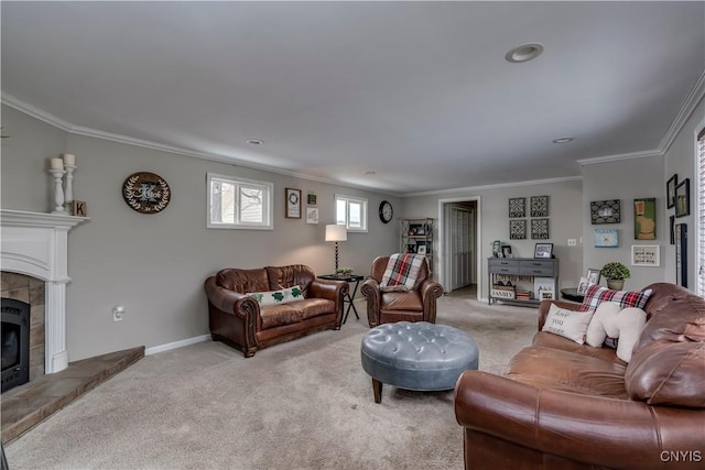 living area featuring light carpet, a fireplace, baseboards, and crown molding