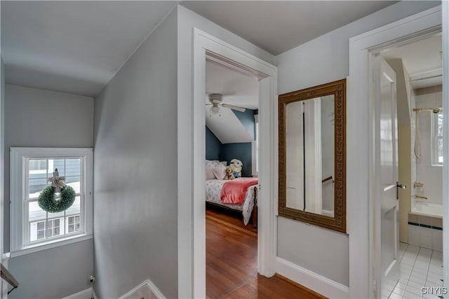 hall featuring wood finished floors and baseboards